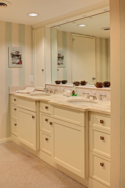 traditional bathroom vanity painted white with square knobs