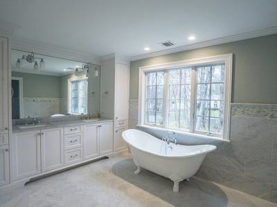 double bathroom vanity with large window and large tub