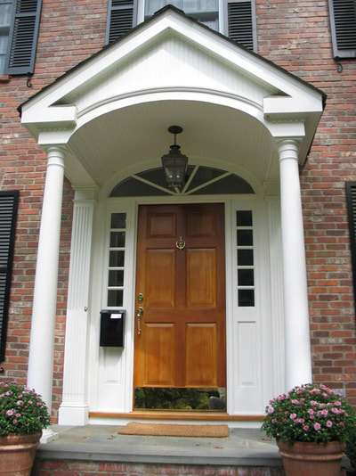 front entry way to a new jersey home with a solid wooden door