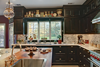 wooden top for a kitchen island with a sing and custom cabinetry
